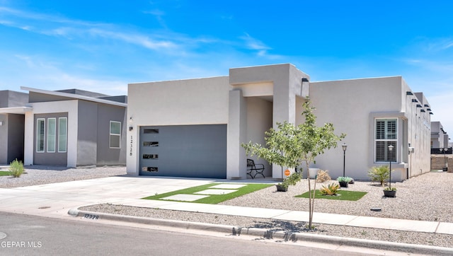 12328 Desert Heights Ct, El Paso, TX 79938 - view of front facade with an attached garage, concrete driveway, and stucco siding