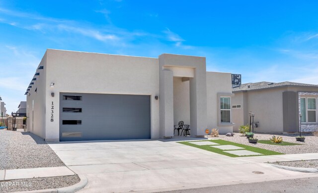 12328 Desert Heights Ct, El Paso, TX 79938 - view of front of home with an attached garage, stucco siding, and driveway