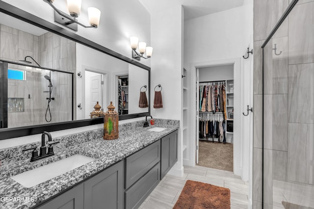 12328 Desert Heights Ct, El Paso, TX 79938 - full bathroom featuring a spacious closet, a stall shower, double vanity, built in shelves, and a chandelier
