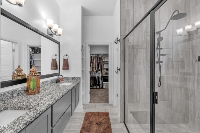12328 Desert Heights Ct, El Paso, TX 79938 - bathroom with a walk in closet, double vanity, a shower stall, and tile patterned flooring