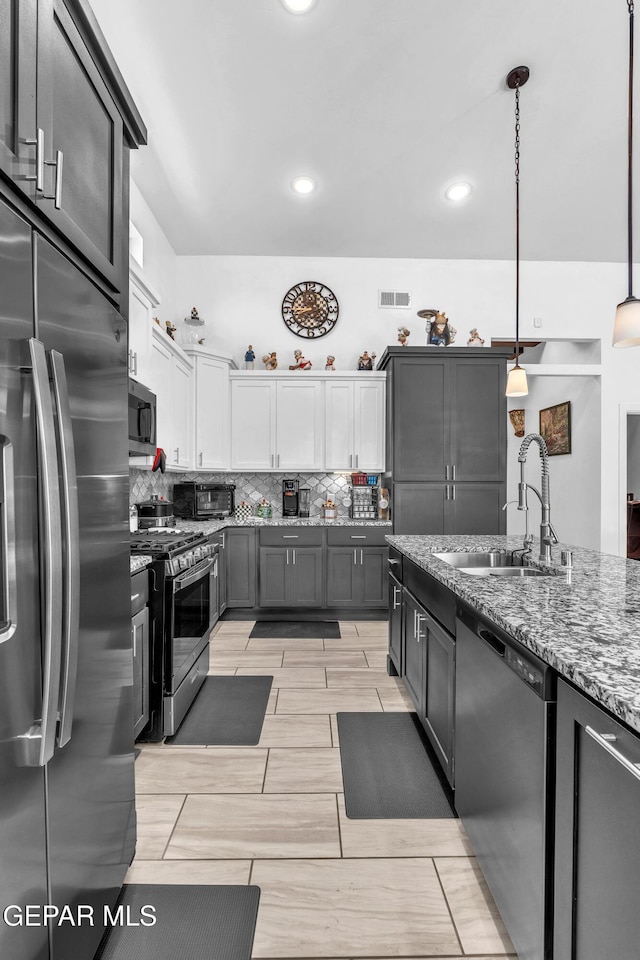 12328 Desert Heights Ct, El Paso, TX 79938 - kitchen featuring stainless steel appliances, stone counters, backsplash, white cabinetry, and hanging light fixtures
