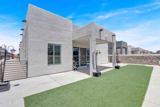 12328 Desert Heights Ct, El Paso, TX 79938 - rear view of house with stucco siding and a patio area
