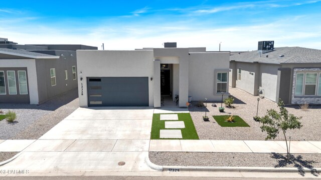12328 Desert Heights Ct, El Paso, TX 79938 - view of front facade featuring concrete driveway, stucco siding, and a garage