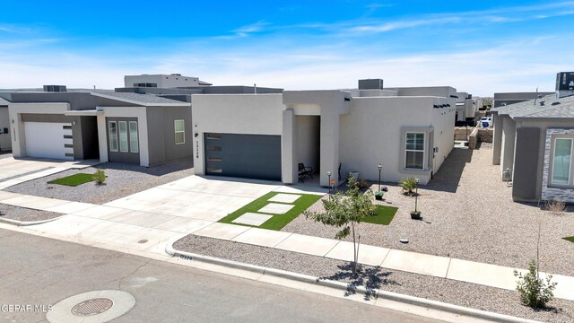 12328 Desert Heights Ct, El Paso, TX 79938 - view of front of home with stucco siding, driveway, a garage, and a residential view