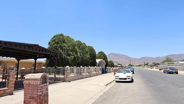 5028 Sagittarius Ave, El Paso, TX 79924 - view of asphalt street with a mountain view, sidewalks, and curbs