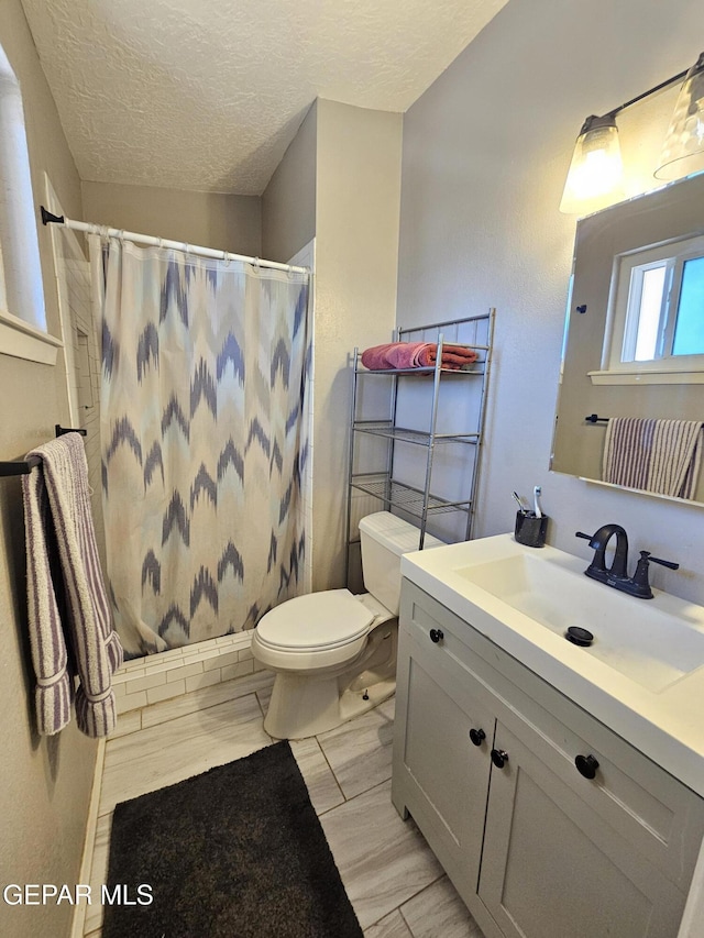 5028 Sagittarius Ave, El Paso, TX 79924 - full bathroom featuring vanity, curtained shower, and a textured ceiling