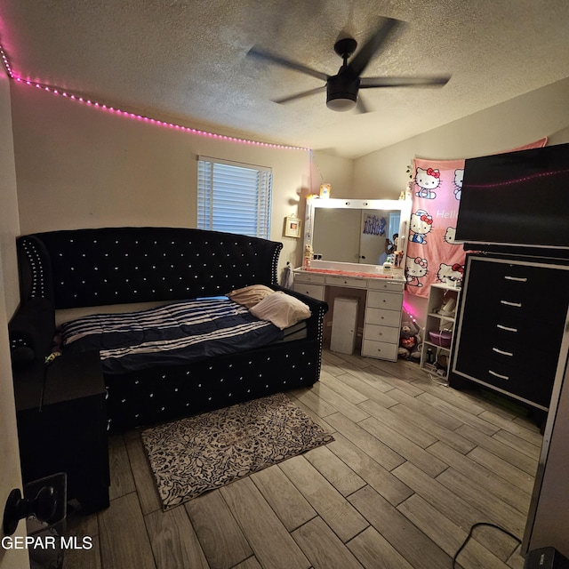 5028 Sagittarius Ave, El Paso, TX 79924 - bedroom with wood finished floors, a textured ceiling, and a ceiling fan