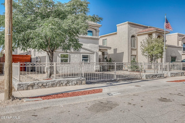 14376 N Cave Dr, El Paso, TX 79938 - view of front of property featuring stucco siding, a tiled roof, and a fenced front yard