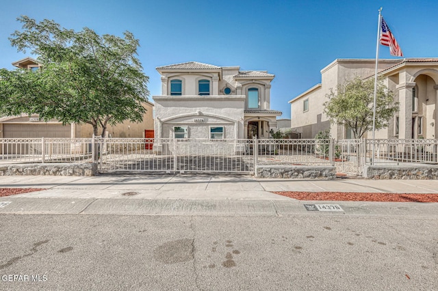 14376 N Cave Dr, El Paso, TX 79938 - mediterranean / spanish-style house featuring stucco siding, a fenced front yard, a tiled roof, and a gate