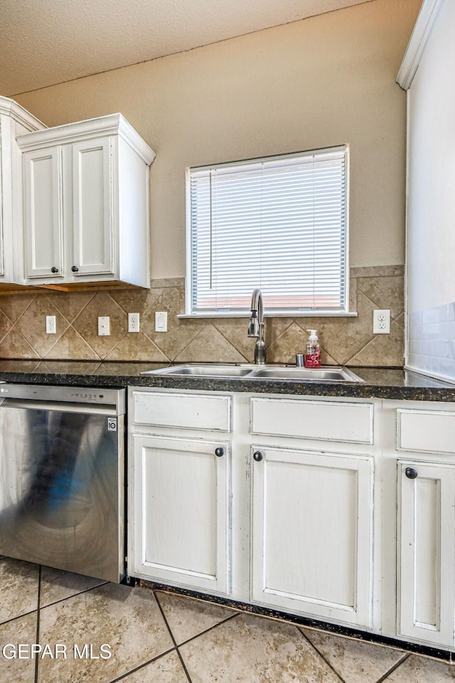 14376 N Cave Dr, El Paso, TX 79938 - kitchen featuring stainless steel dishwasher, dark countertops, backsplash, and light tile patterned floors
