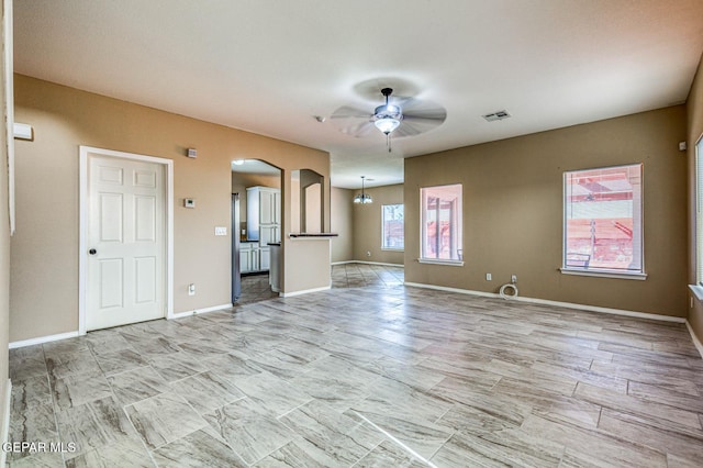 14376 N Cave Dr, El Paso, TX 79938 - unfurnished living room featuring ceiling fan and arched walkways