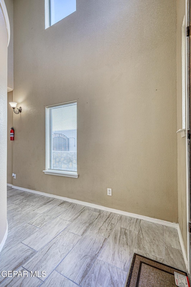 14376 N Cave Dr, El Paso, TX 79938 - spare room with baseboards and a high ceiling