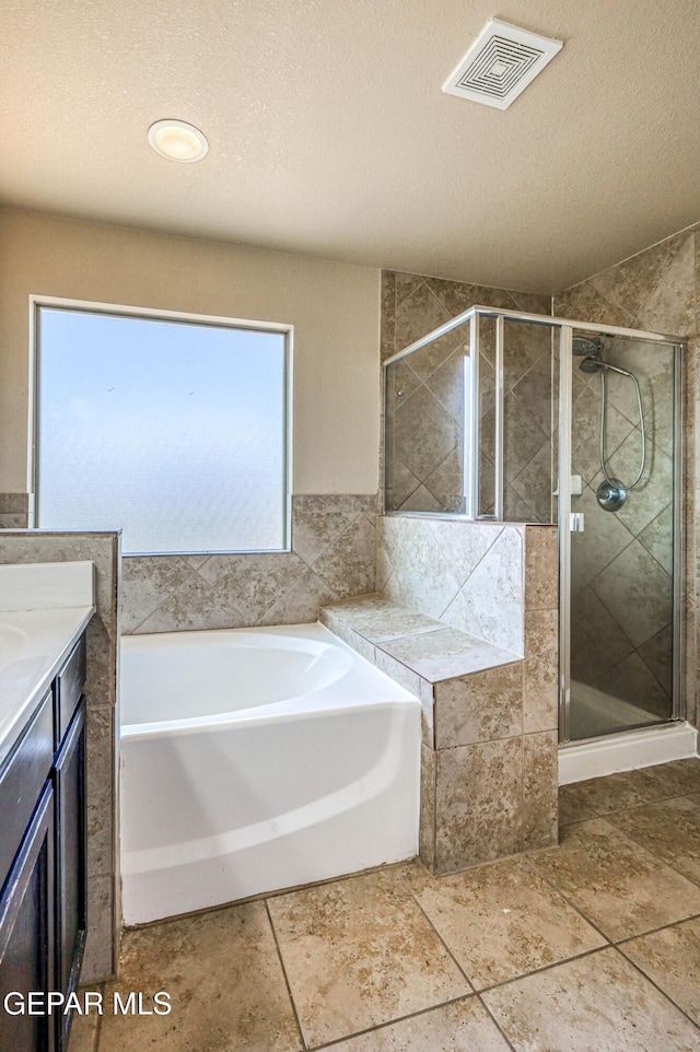 14376 N Cave Dr, El Paso, TX 79938 - bathroom with a garden tub, a shower stall, vanity, and a textured ceiling