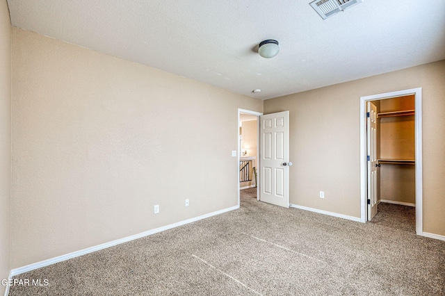 14376 N Cave Dr, El Paso, TX 79938 - unfurnished bedroom featuring carpet floors, a spacious closet, and a closet