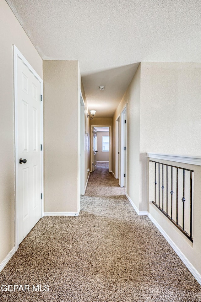 14376 N Cave Dr, El Paso, TX 79938 - corridor featuring carpet flooring and a textured ceiling