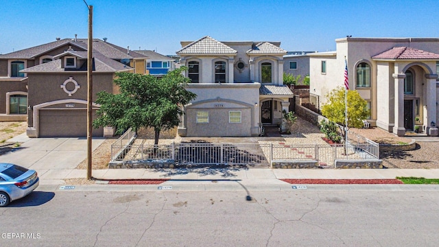 14376 N Cave Dr, El Paso, TX 79938 - view of front of property with a tile roof, a fenced front yard, concrete driveway, stucco siding, and a garage