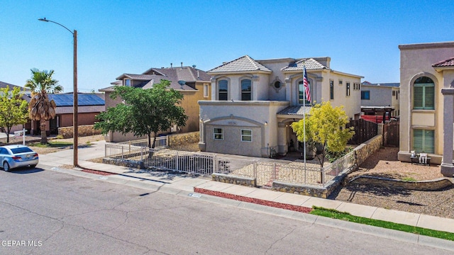 14376 N Cave Dr, El Paso, TX 79938 - view of front of property featuring a fenced front yard, stucco siding, and a tile roof