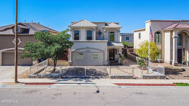 14376 N Cave Dr, El Paso, TX 79938 - mediterranean / spanish-style house with a tile roof, a fenced front yard, stucco siding, a garage, and driveway