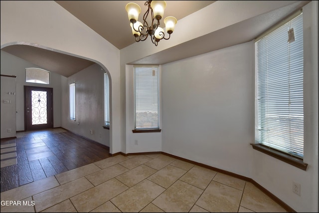 4908 Gold Ranch Ave, El Paso, TX 79934 - entrance foyer featuring vaulted ceiling, plenty of natural light, arched walkways, a chandelier, and light tile patterned flooring