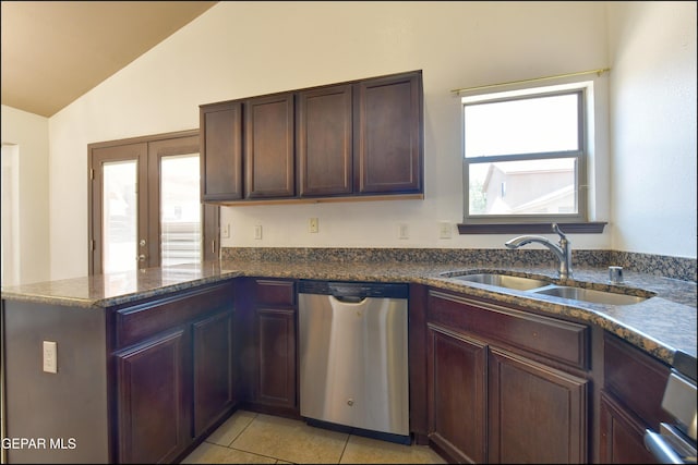 4908 Gold Ranch Ave, El Paso, TX 79934 - kitchen featuring dishwasher, vaulted ceiling, light tile patterned floors, a peninsula, and dark stone counters