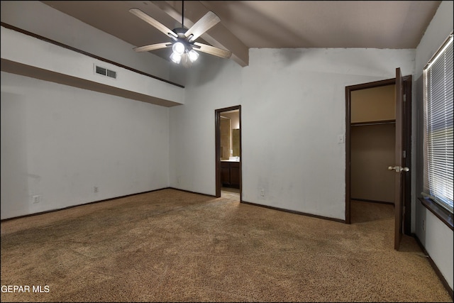4908 Gold Ranch Ave, El Paso, TX 79934 - unfurnished bedroom with vaulted ceiling, light carpet, a walk in closet, connected bathroom, and a closet
