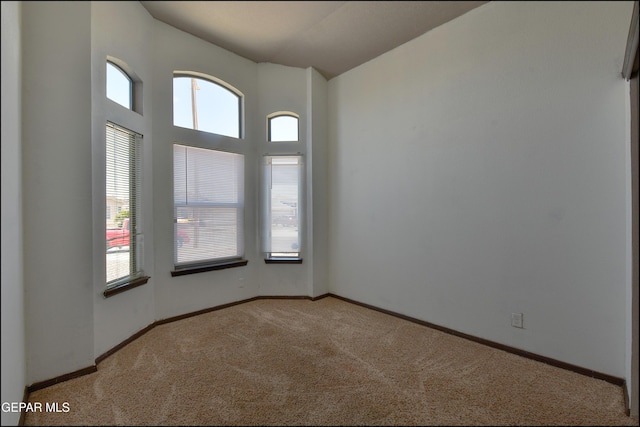 4908 Gold Ranch Ave, El Paso, TX 79934 - empty room featuring light carpet, healthy amount of natural light, and high vaulted ceiling