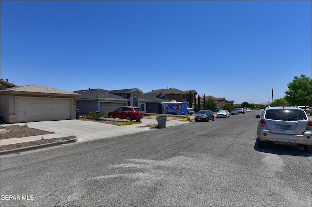 4908 Gold Ranch Ave, El Paso, TX 79934 - view of asphalt road featuring a residential view, sidewalks, and curbs