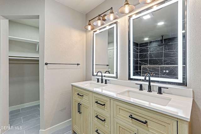 5112 Sun Valley Dr, El Paso, TX 79924 - bathroom featuring double vanity, a spacious closet, and tile patterned floors