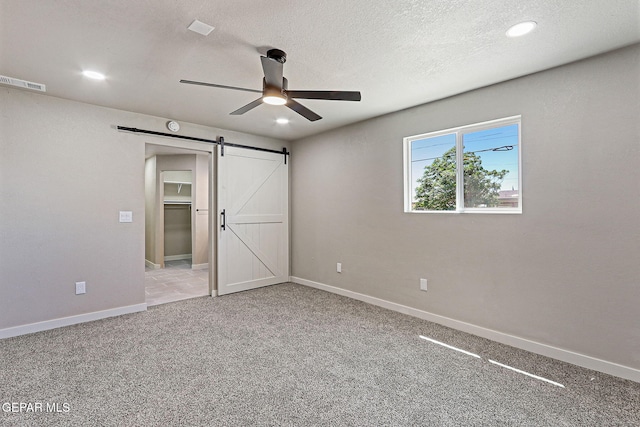 5112 Sun Valley Dr, El Paso, TX 79924 - unfurnished bedroom with a barn door, carpet, recessed lighting, a ceiling fan, and a textured ceiling
