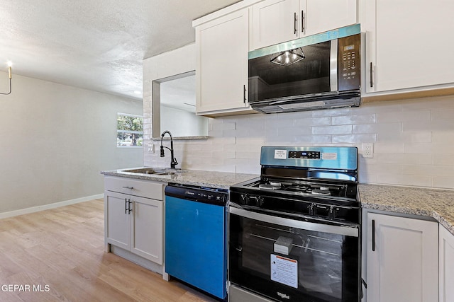 5112 Sun Valley Dr, El Paso, TX 79924 - kitchen featuring stainless steel appliances, light wood-style flooring, tasteful backsplash, light stone counters, and a textured ceiling