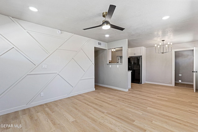 5112 Sun Valley Dr, El Paso, TX 79924 - empty room with a chandelier, light wood-style floors, a ceiling fan, recessed lighting, and a decorative wall