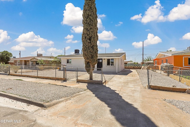 5112 Sun Valley Dr, El Paso, TX 79924 - view of front of property with a gate, concrete driveway, a fenced front yard, a residential view, and stucco siding