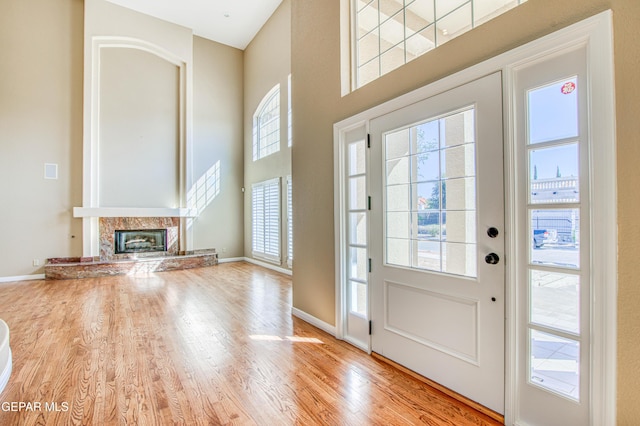6570 Eagle Ridge Dr, El Paso, TX 79912 - foyer with a towering ceiling, wood finished floors, and a fireplace