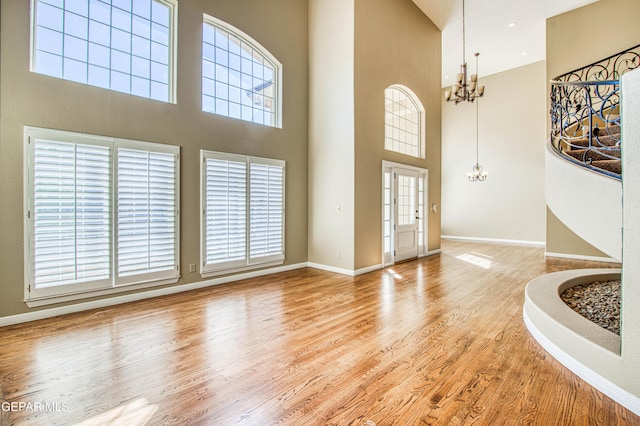 6570 Eagle Ridge Dr, El Paso, TX 79912 - entrance foyer featuring a chandelier, a towering ceiling, and wood finished floors