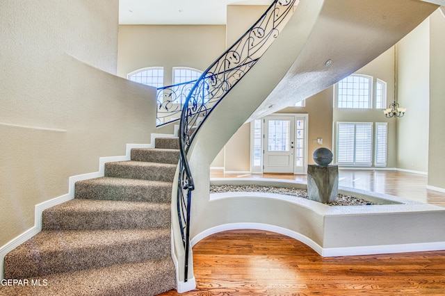 6570 Eagle Ridge Dr, El Paso, TX 79912 - stairway featuring wood finished floors and a high ceiling