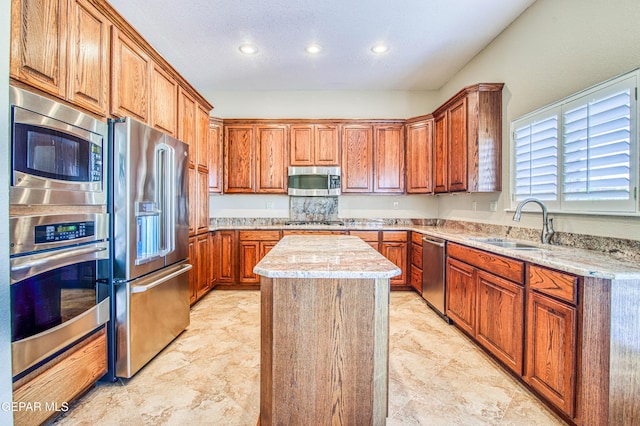 6570 Eagle Ridge Dr, El Paso, TX 79912 - kitchen featuring stainless steel appliances, a kitchen island, recessed lighting, and brown cabinetry