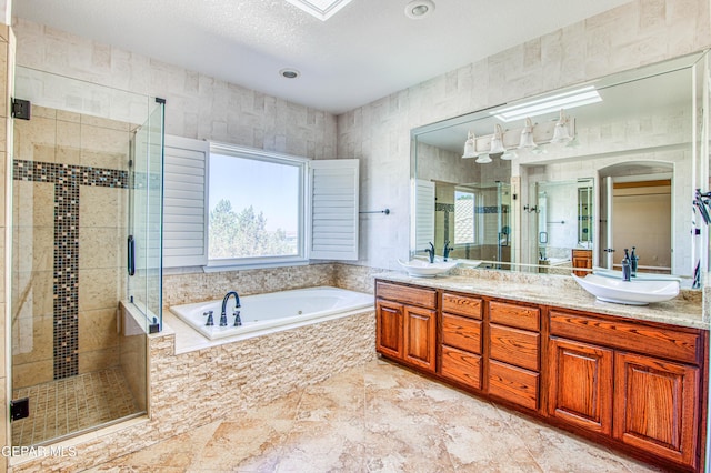 6570 Eagle Ridge Dr, El Paso, TX 79912 - full bathroom featuring double vanity, a shower stall, and a garden tub