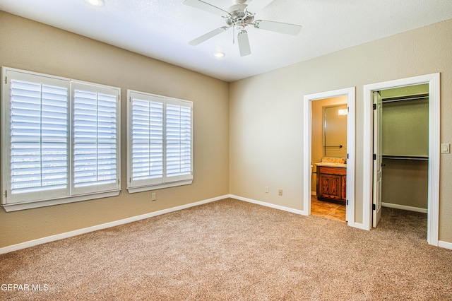6570 Eagle Ridge Dr, El Paso, TX 79912 - unfurnished bedroom featuring a spacious closet, carpet floors, ensuite bathroom, recessed lighting, and a closet