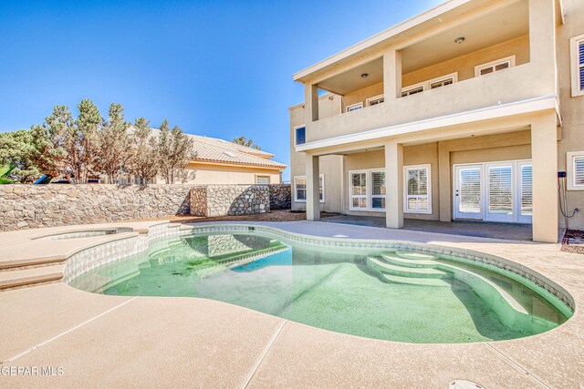 6570 Eagle Ridge Dr, El Paso, TX 79912 - view of swimming pool featuring a patio area, a pool with connected hot tub, and french doors