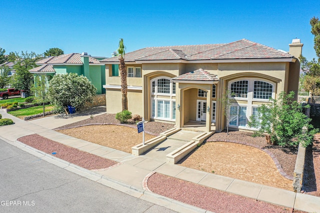 6570 Eagle Ridge Dr, El Paso, TX 79912 - mediterranean / spanish-style home featuring french doors, stucco siding, a tiled roof, and a chimney