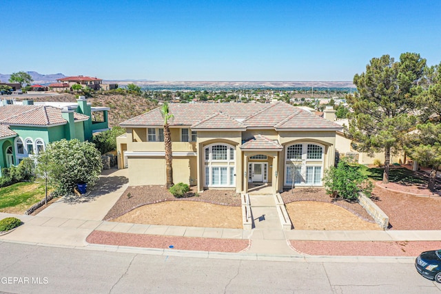6570 Eagle Ridge Dr, El Paso, TX 79912 - mediterranean / spanish-style house featuring stucco siding, concrete driveway, and a tile roof