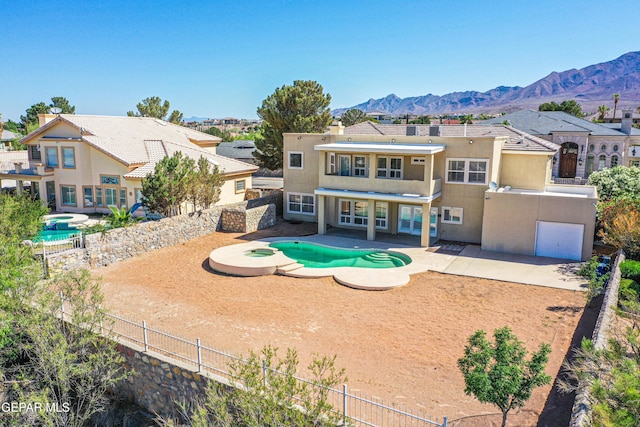 6570 Eagle Ridge Dr, El Paso, TX 79912 - rear view of property with a pool with connected hot tub, a fenced backyard, stucco siding, and a mountain view