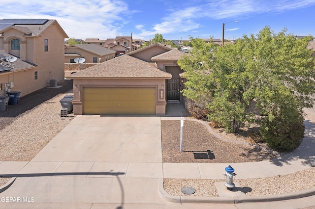 14477 Jacinto Ramos Ave, El Paso, TX 79938 - view of front of house featuring a garage, concrete driveway, stucco siding, a residential view, and roof with shingles