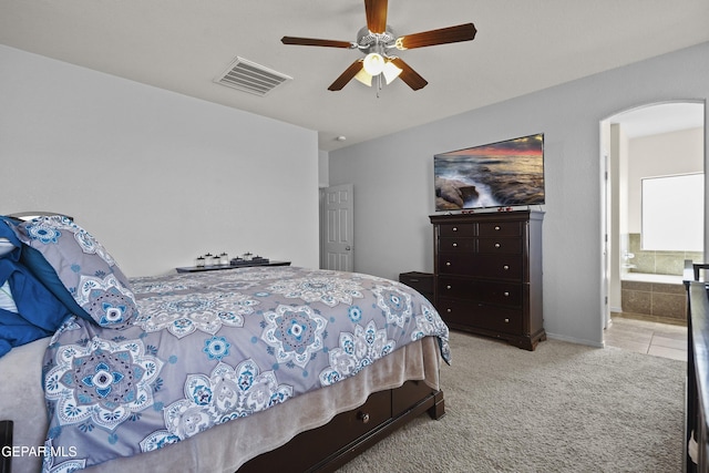 14477 Jacinto Ramos Ave, El Paso, TX 79938 - bedroom featuring arched walkways, carpet flooring, ensuite bathroom, and a ceiling fan