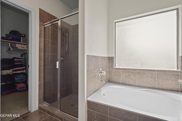 14477 Jacinto Ramos Ave, El Paso, TX 79938 - bathroom featuring a stall shower, a garden tub, a spacious closet, and tile patterned flooring