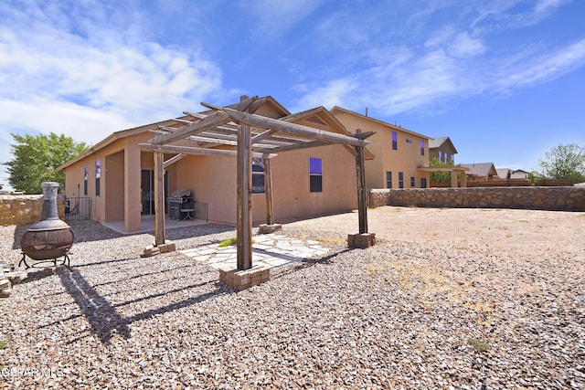 14477 Jacinto Ramos Ave, El Paso, TX 79938 - back of house featuring an outdoor fire pit, a pergola, stucco siding, and a patio