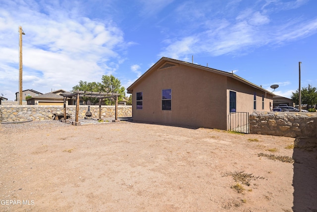 14477 Jacinto Ramos Ave, El Paso, TX 79938 - view of side of home with a pergola and stucco siding