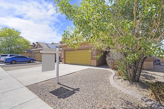 14477 Jacinto Ramos Ave, El Paso, TX 79938 - obstructed view of property with concrete driveway, a garage, and stucco siding