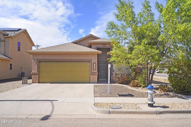 14477 Jacinto Ramos Ave, El Paso, TX 79938 - view of front of home with stucco siding, concrete driveway, and a garage