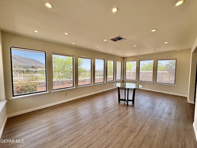 536 Satellite Dr, El Paso, TX 79912 - spare room featuring plenty of natural light, recessed lighting, and wood finished floors